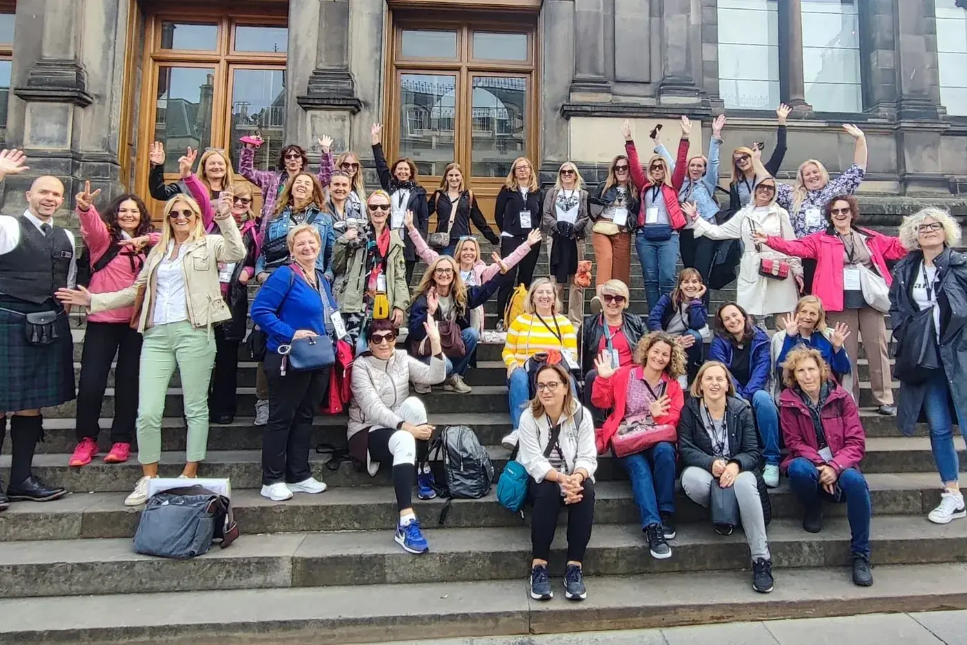 A large Historic Edinburgh Tours group photographed together on museum steps